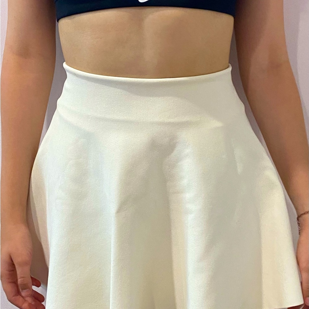 A pretty cream party skirt that twirls.